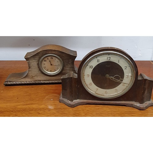 566 - A good quantity of 20th Century Clocks to include a pair of binoculars.