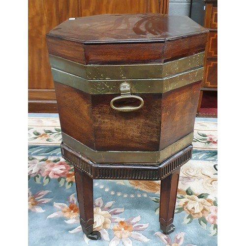 585 - An early 19th Century Mahogany and Brass bound Wine Cooler with heavy brass lifting handles, brass s... 