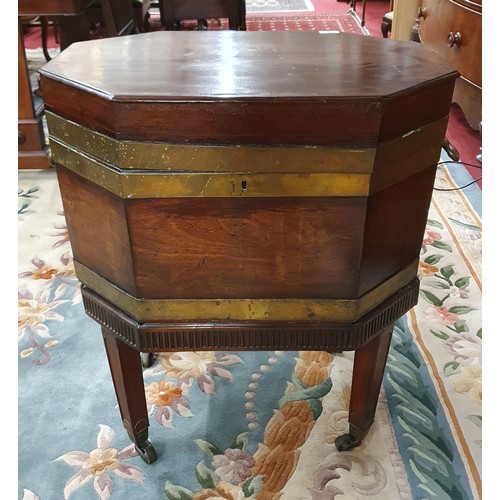 585 - An early 19th Century Mahogany and Brass bound Wine Cooler with heavy brass lifting handles, brass s... 