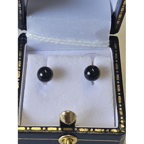 637 - A pair of 9ct Gold and Onyx Earrings.