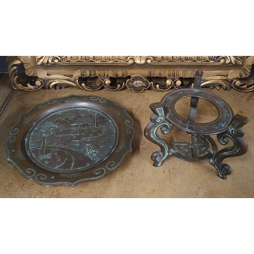 737 - A good Oriental Bronze Plate on stand with a highly carved and moulded outline (stand needs repair).... 