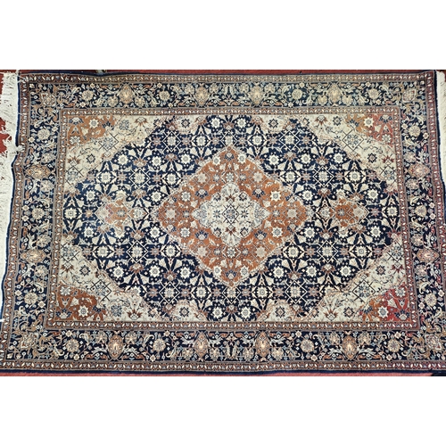 744 - A good Persian Blue ground Rug with multi borders and a unique central medallion design.
L 190 x W 1... 