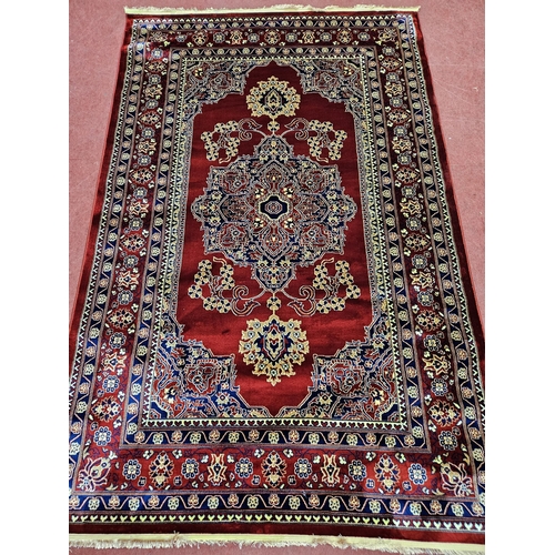 1 - A red ground Turkish Soft Full Pile Carpet with central repeated panel design surrounded by borders ... 