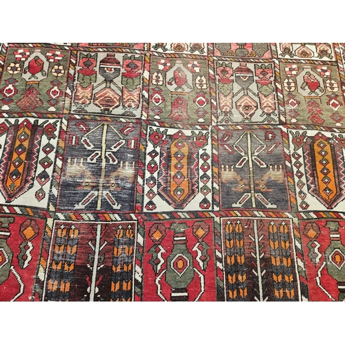 10 - A hand woven naturally died Persian Bacteria village Carpet with a traditional Persian panel design,... 