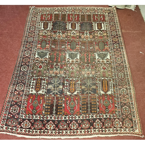 10 - A hand woven naturally died Persian Bacteria village Carpet with a traditional Persian panel design,... 