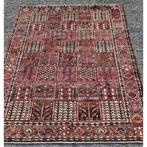 11 - A hand woven Persian Bakhtiari Carpet with a traditional panel design, 295 x 200 cm approx