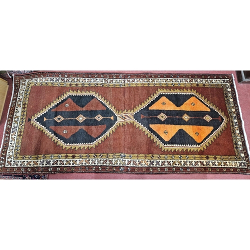 15 - A Terracotta ground hand woven Persian Qashqai nomadic Runner with a double medallion design, 275 x ... 