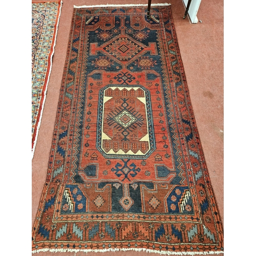 17 - A burnt Orange and Blue ground hand woven Iranian village Runner with bespoke design, 265 x 126cm ap... 