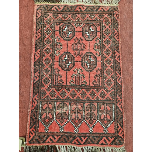 22 - A red ground Persian Rug. L 113 x W 67 cm approx.