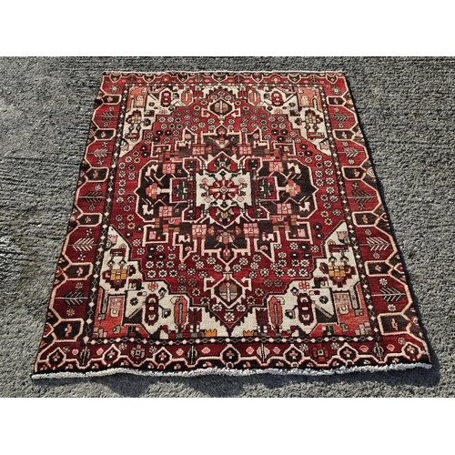 38 - A hand woven burgundy ground  Persian Village Rug from the Bhatia province of Iran,  200 x 155 cm ap... 