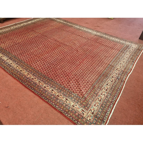 42 - A washed Red ground handwoven Persian Shahrukh Mia Carpet with an all over design.
L 348  x W 262 cm... 