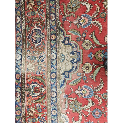 44 - A large Persian Red ground Carpet with a unique central medallion design 400 x 300 cm approx.