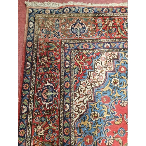 44 - A large Persian Red ground Carpet with a unique central medallion design 400 x 300 cm approx.