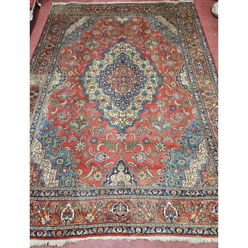 44 - A large Persian Red ground Carpet with a unique central medallion design 400 x 300 cm approx.