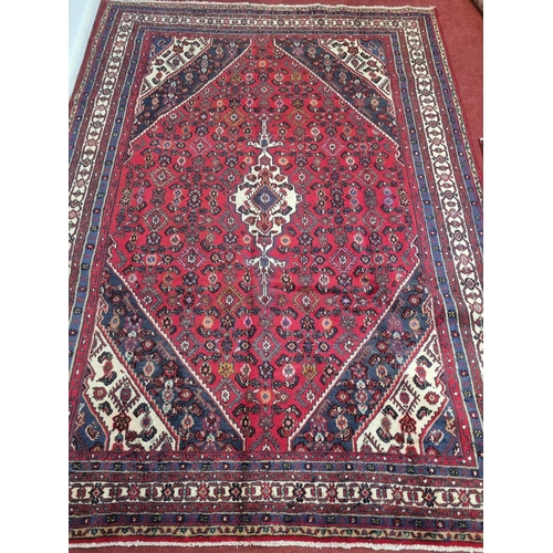 48 - A Persian Surok Carpet with an allover design and a central medallion surrounded by a thick border. ... 