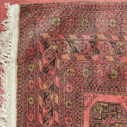 52 - A red ground Rug with repeating decoration. (some faults) .
 297 x 205 cm approx.