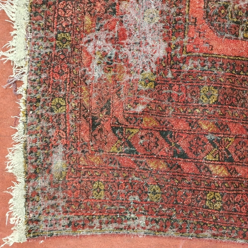 52 - A red ground Rug with repeating decoration. (some faults) .
 297 x 205 cm approx.