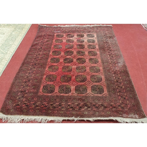 52 - A red ground Rug with repeating decoration. (some faults) .
 297 x 205 cm approx.