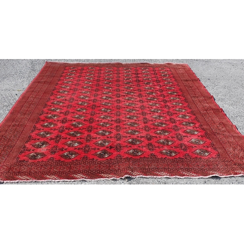 57 - A large Red ground Iranian Carpet with repeating central medallion design 355 x 303 cm approx.