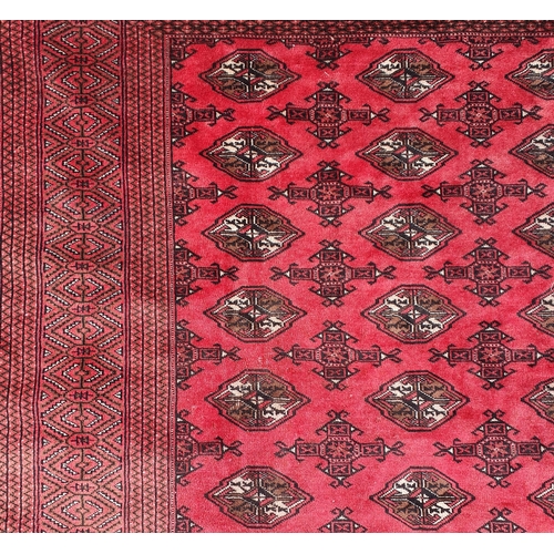 57 - A large Red ground Iranian Carpet with repeating central medallion design 355 x 303 cm approx.