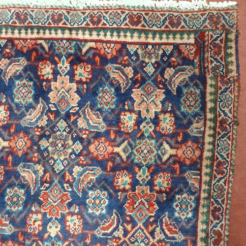 62 - A Blue ground Persian Carpet with repeating central medallion design, 260  x 164 cm approx.