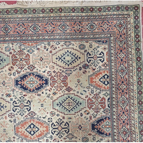 66 - A Cream ground Carpet with repeating central medallion design.  340 x 240  cm approx.