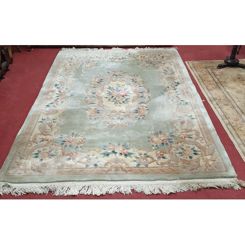 69 - An Oriental style green ground carpet .
L 290 x W 180 cm approx.