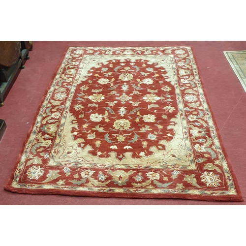 72 - A Red and Cream ground deep pile Carpet. 243 x 166 cm approx.