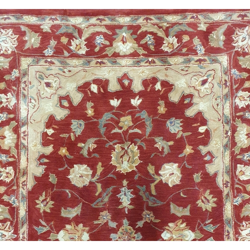 72 - A Red and Cream ground deep pile Carpet. 243 x 166 cm approx.