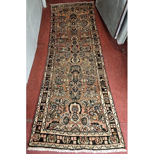 75 - A washed Red ground hand woven Persian  Runner with a floral design. 288 x 99cm approx.