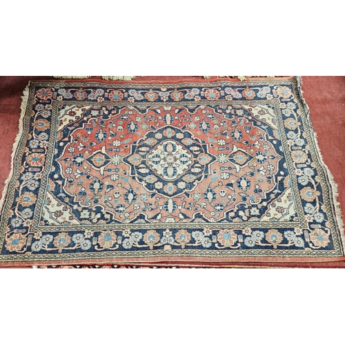 76 - A Persian red ground Rug with multi borders and unique central medallion design 195cm x 132cm approx... 