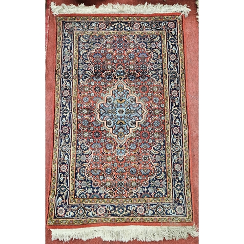 77 - A good Persian red ground Rug with multi borders and unique medallion design 122cm x 79cm approx.