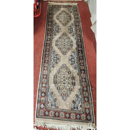 82 - A good pink ground Runner with multi borders and repeating central medallion design. 275 x 79 cm app... 