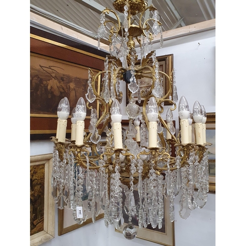 152 - A Magnificent eight branch Brass and Crystal Chandelier profusely decorated with drop crystals. W 65... 