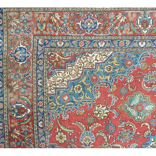 44 - A large Persian Red ground Carpet with a unique central medallion design 400 x 300 cm approx.