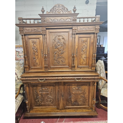 17 - A good 19th Century triple door Walnut Side Cabinet with highly carved panel front and reeded column... 