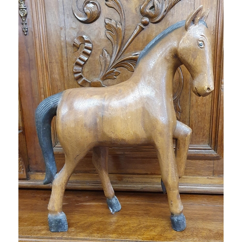 103 - A Timber Figure of a Horse. H 38 cm approx.