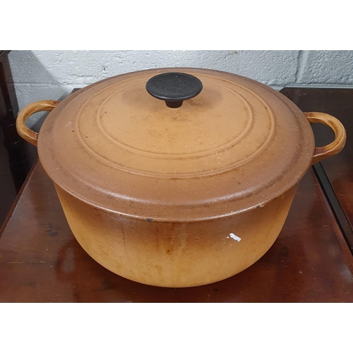 112 - A Le Creuset brown ground lidded Saucepan. D 27 cm approx.