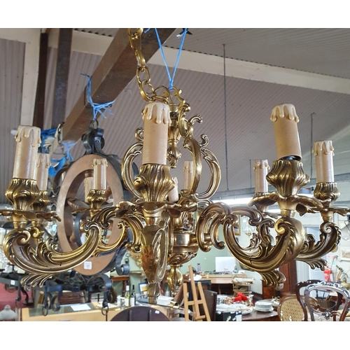 136 - A good Brass eight branch Chandelier with highly moulded outline.