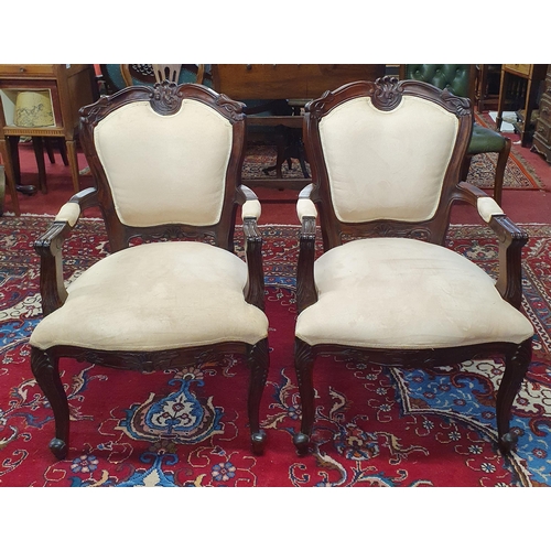 143 - A pair of Mahogany showframe Armchairs with cream suede upholstery on carved cabriole front supports... 