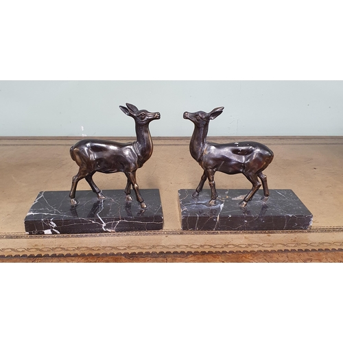 187 - A pair of Metal Bookends depicting deer standing on Marble bases. H 15 cm approx.