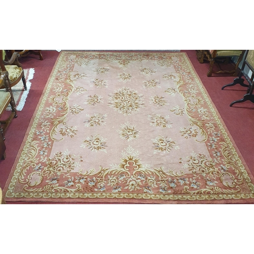 196 - A good pink ground Carpet with a unique central medallion design and multi borders. 372 x 250cm appr... 