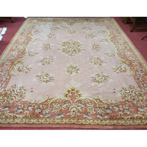 196 - A good pink ground Carpet with a unique central medallion design and multi borders. 372 x 250cm appr... 