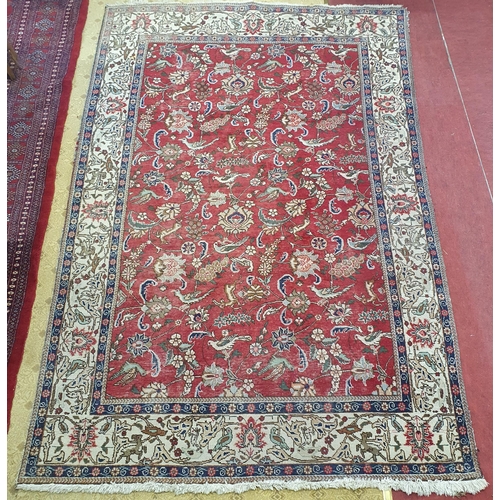 200 - A good Persian cream and red ground Carpet with floral central medallion design and multi borders. W... 