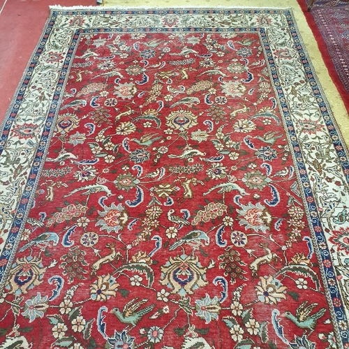 200 - A good Persian cream and red ground Carpet with floral central medallion design and multi borders. W... 