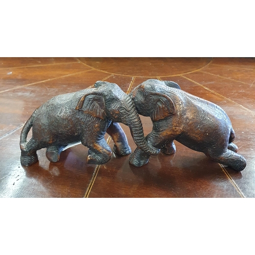 212 - A Figural group of loving Elephants. W 23 x H 9 cm approx.