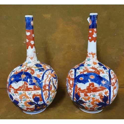 250 - A large pair of 19th Century Imari patterned Bud Vases. One in good condition, one AF. H 31 cm appro... 