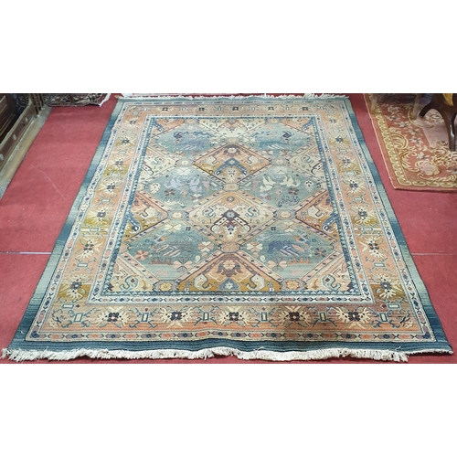 266 - A good green ground Carpet with multi borders and Aztec style design. 200 x 280 cm approx.