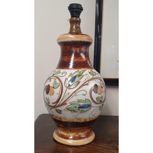 49 - An extremely large bulbous moulded Terracotta Table Lamp with floral outline. H 50 cm approx.