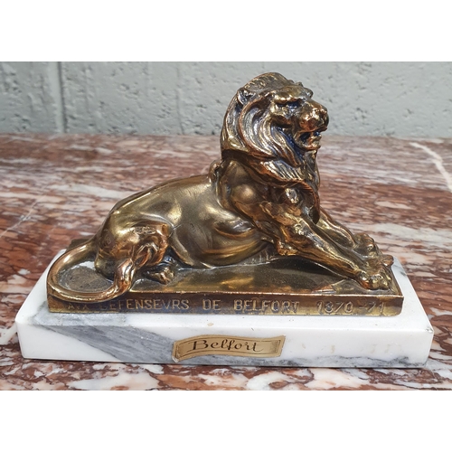 53 - A Metal Figure of a Lion in repose with inscription.